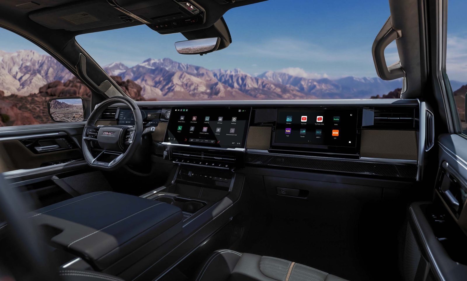 2027 GMC Sierra 1500 AT4X dashboard with 16.3-inch touchscreen and passenger display showing streaming apps