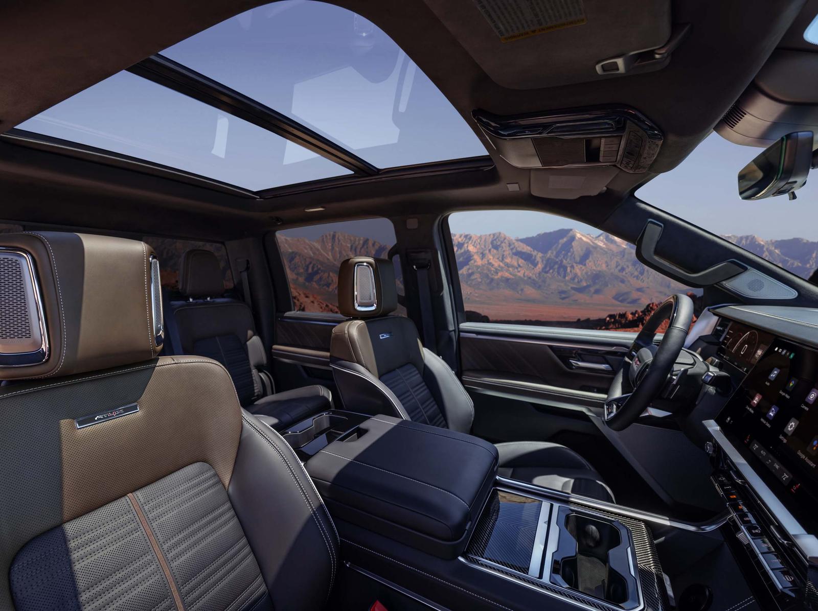 2027 GMC Sierra 1500 AT4X cabin with two-tone leather seats, headrest speakers, and panoramic sunroof