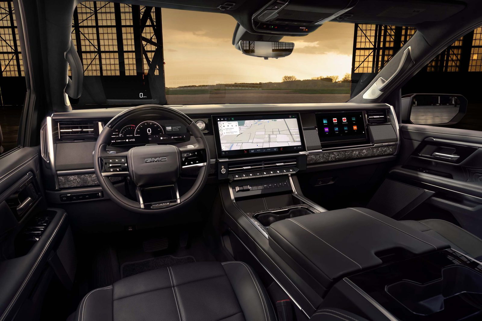 Denali Ultimate dashboard with 12.2-inch driver display, 16.3-inch center touchscreen showing navigation, and passenger display